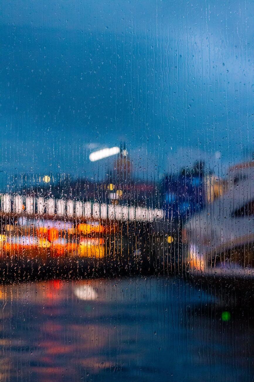 blurred cityscape through rainy window at night