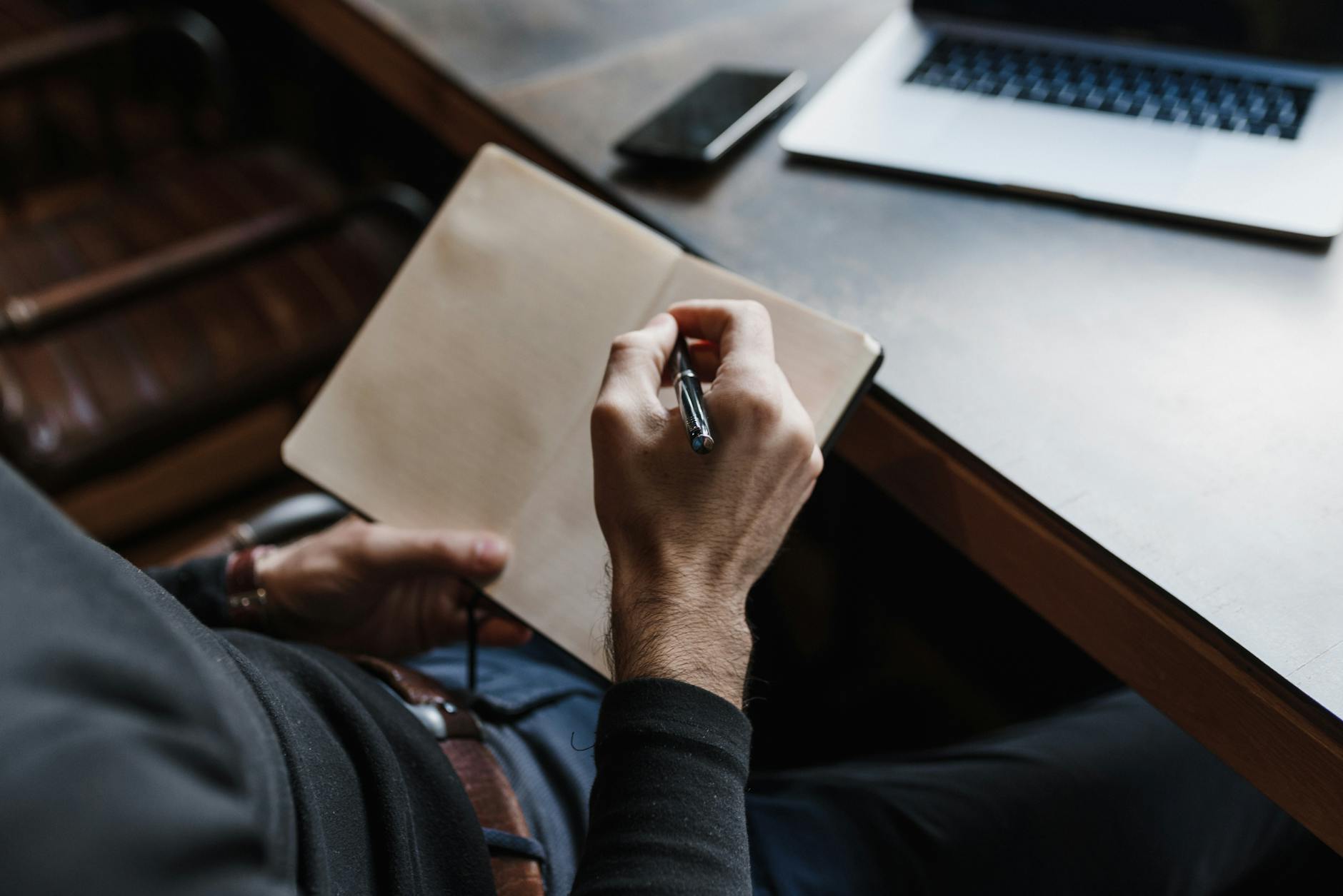 a person writing in the notebook