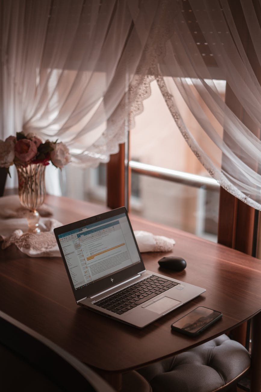 laptop on brown wooden table