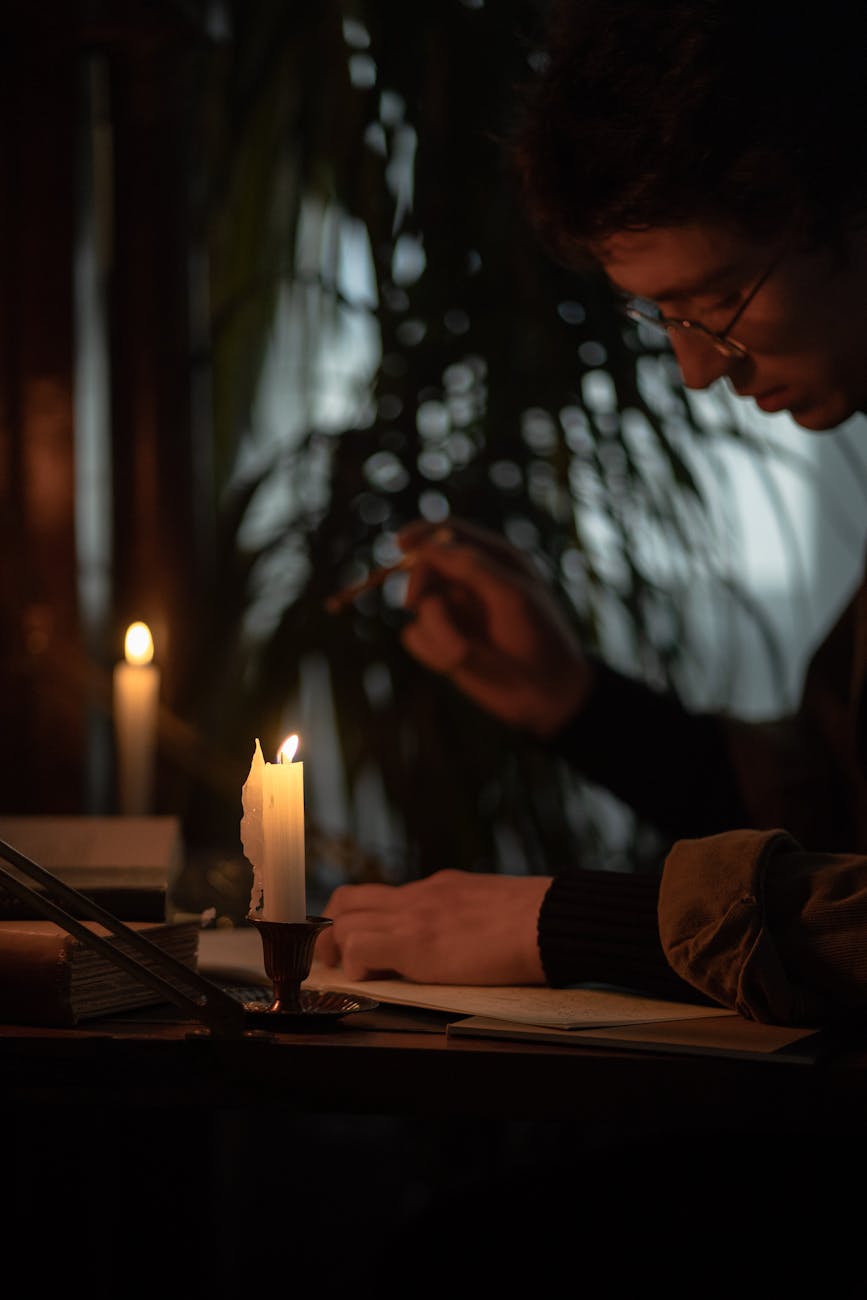 a man writing in the dark room
